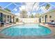Beautiful screened pool and spa with plenty of seating at 3527 Conifer Loop, Spring Hill, FL 34609