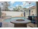 Inviting pool area with a fire pit and covered patio at 3527 Conifer Loop, Spring Hill, FL 34609