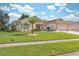 House exterior with palm trees and a well-kept lawn at 3527 Conifer Loop, Spring Hill, FL 34609