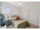 Spacious bedroom with a queen-size bed, ample closet space, and a ceiling fan at 3527 Conifer Loop, Spring Hill, FL 34609