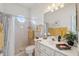 Clean bathroom with shower, vanity, and plenty of towels at 3527 Conifer Loop, Spring Hill, FL 34609
