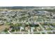 Aerial view of a neighborhood, showing many houses with pools and lush landscaping at 3527 Conifer Loop, Spring Hill, FL 34609