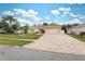 One-story house with a geometric driveway and palm trees at 3527 Conifer Loop, Spring Hill, FL 34609