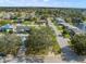 High-angle view of residential neighborhood with houses and a pond at 3902 Glissade Dr, New Port Richey, FL 34652