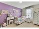 Charming bedroom with purple walls and white furniture at 4166 Sand Ridge Blvd, Spring Hill, FL 34609