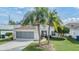 Single-story house with screened garage and palm trees at 4222 Northampton Dr, New Port Richey, FL 34653