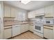 Clean and bright kitchen with white cabinets and appliances at 4222 Northampton Dr, New Port Richey, FL 34653
