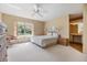 Spacious main bedroom with large window, ceiling fan, and en-suite bathroom access at 4222 Northampton Dr, New Port Richey, FL 34653