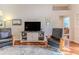 Relaxing living room with two leather armchairs and a media console at 480 Fort Mill Ln, Spring Hill, FL 34609