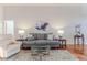 Living Room with gray couch, hardwood floors, and a glass coffee table at 480 Fort Mill Ln, Spring Hill, FL 34609