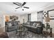 Living room featuring a comfy gray sectional sofa and a glass coffee table at 6060 Silverdale Ave, Spring Hill, FL 34608