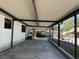 Exterior view from the carport with tiki hut at 6176 Island Dr, Weeki Wachee, FL 34607