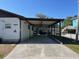Wide view of the covered carport and home exterior at 6176 Island Dr, Weeki Wachee, FL 34607