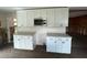 White shaker cabinets, new countertops, and microwave at 6176 Island Dr, Weeki Wachee, FL 34607