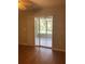 Bedroom with sliding glass doors leading to a screened patio at 6429 Remus Dr, New Port Richey, FL 34653