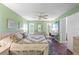 Main bedroom with king bed, workspace, and wood floors at 6489 Mulligan Ct, Spring Hill, FL 34606