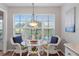 Kitchen breakfast nook with wicker chairs and a glass-top table at 6489 Mulligan Ct, Spring Hill, FL 34606