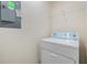 Bright laundry room with washer, dryer, and shelving at 7650 Red Mill Cir, New Port Richey, FL 34653