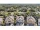 Aerial view of townhouses with gray roofs and tan siding at 7650 Red Mill Cir, New Port Richey, FL 34653