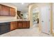 Kitchen with wood cabinets, view into adjacent dining area at 7650 Red Mill Cir, New Port Richey, FL 34653