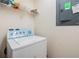 Laundry room features washer, dryer, and overhead shelving at 7650 Red Mill Cir, New Port Richey, FL 34653