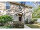 Inviting two-story townhome exterior with landscaping and walkway at 7650 Red Mill Cir, New Port Richey, FL 34653
