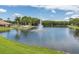 Community lake with fountain, palm trees at 9320 Trowbridge Ct, New Port Richey, FL 34655