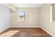 Spacious bedroom with hardwood floors and large window at 1013 Marlow Ave, Spring Hill, FL 34606