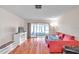 Living room with coral sofa and wood floors, leading to a screened porch at 11231 Dollar Lake Dr # 4, Port Richey, FL 34668