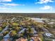 Aerial view of a community featuring homes, trees, and a lake at 11231 Dollar Lake Dr # 4, Port Richey, FL 34668