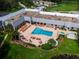 Aerial view of community pool with lounge chairs and surrounding landscape at 11610 Boynton Ln, New Port Richey, FL 34654