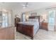 Spacious main bedroom with wood furniture and tile floors at 12224 Mango Ct, Spring Hill, FL 34609