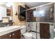 Clean bathroom with a shower/tub combo and dark vanity at 15134 Peoria Ave, Hudson, FL 34667