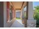 Side view of the porch with stone accents and red shutters at 15724 Peruvian Lily Ct, Brooksville, FL 34604