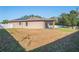 House exterior with solar panels and fenced yard at 15724 Peruvian Lily Ct, Brooksville, FL 34604