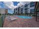 Relaxing kidney-shaped pool with lounge chairs and brick patio at 4620 Bay Blvd # 1148, Port Richey, FL 34668