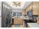 Kitchen with stainless steel appliances and wood cabinets at 8141 Aquila St # 347, Port Richey, FL 34668