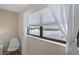 Bedroom with water views, large window, and white sheer curtains at 8141 Aquila St # 347, Port Richey, FL 34668
