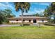 Community center with ample parking and lush green landscaping at 8412 Dunnellon Rd, Weeki Wachee, FL 34613