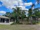 Landscaped backyard with palm trees and garden structures at 10448 Canary Ave, Weeki Wachee, FL 34613