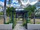 Landscaped backyard with pergola and lush greenery at 10448 Canary Ave, Weeki Wachee, FL 34613