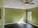 Bright bedroom featuring wood-look floors and a large window at 10448 Canary Ave, Weeki Wachee, FL 34613