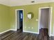 Spacious bedroom with wood-look flooring and access to bathroom at 10448 Canary Ave, Weeki Wachee, FL 34613