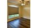 Bedroom with wood-look floors and arched window at 10448 Canary Ave, Weeki Wachee, FL 34613