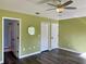 Spacious bedroom with wood-look floors and ceiling fan at 10448 Canary Ave, Weeki Wachee, FL 34613