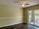 Dining room with dark wood flooring and sliding glass doors to patio at 10448 Canary Ave, Weeki Wachee, FL 34613