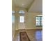 Bright entryway with tile flooring, arched window, and decorative glass door at 10448 Canary Ave, Weeki Wachee, FL 34613