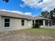 Tan house exterior with multiple windows and a screened porch at 10448 Canary Ave, Weeki Wachee, FL 34613