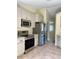 Modern kitchen with stainless steel appliances and light cabinets at 10448 Canary Ave, Weeki Wachee, FL 34613