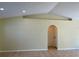 Living room with vaulted ceiling and tile floors at 10448 Canary Ave, Weeki Wachee, FL 34613